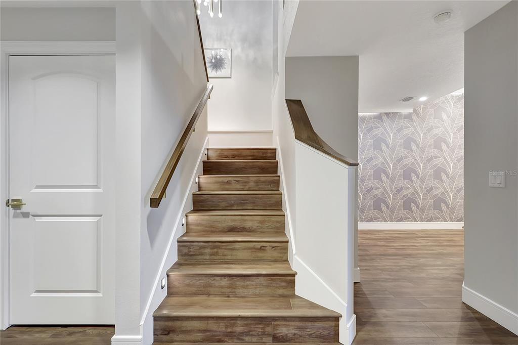 610 Riviera Dunes Way, Unit 602 Palmetto, FL 34221 - Photo 34 of 79 a view of staircase with white walls and white door