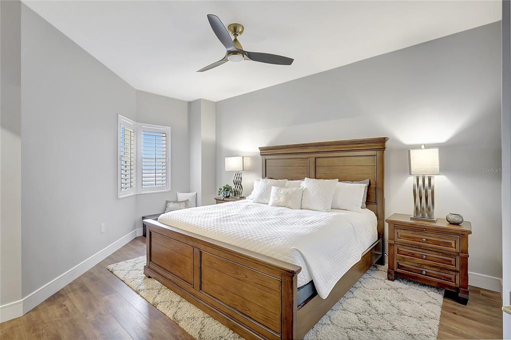 610 Riviera Dunes Way, Unit 602 Palmetto, FL 34221 - Photo 38 of 79 a bedroom with a bed and a ceiling fan