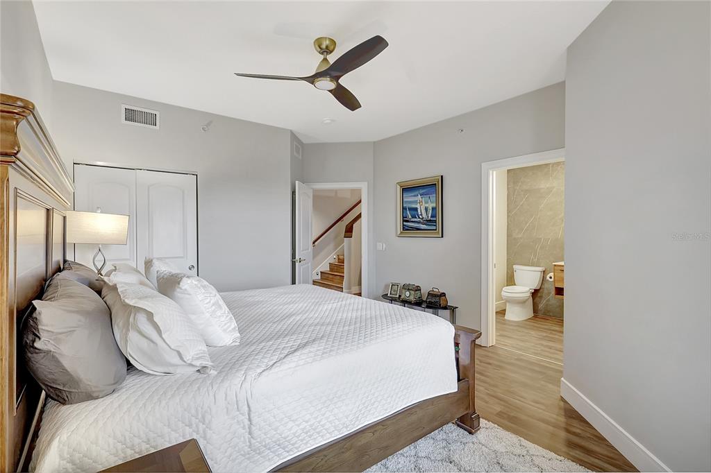 610 Riviera Dunes Way, Unit 602 Palmetto, FL 34221 - Photo 39 of 79 a bedroom with a bed and a chandelier