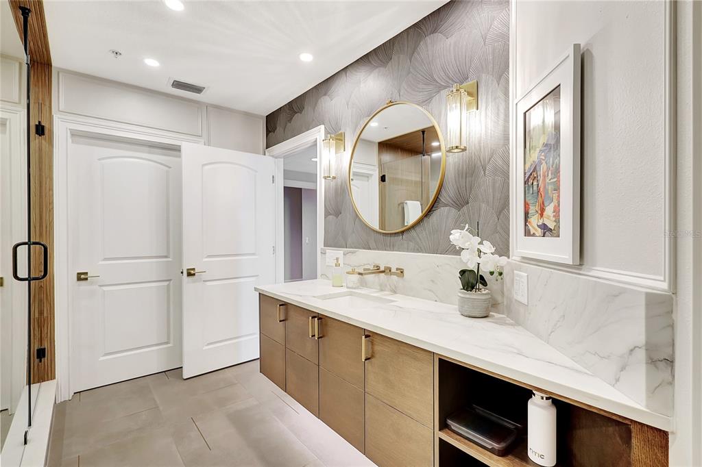 610 Riviera Dunes Way, Unit 602 Palmetto, FL 34221 - Photo 45 of 79 a en suite bathroom with a double vanity sink and a mirror