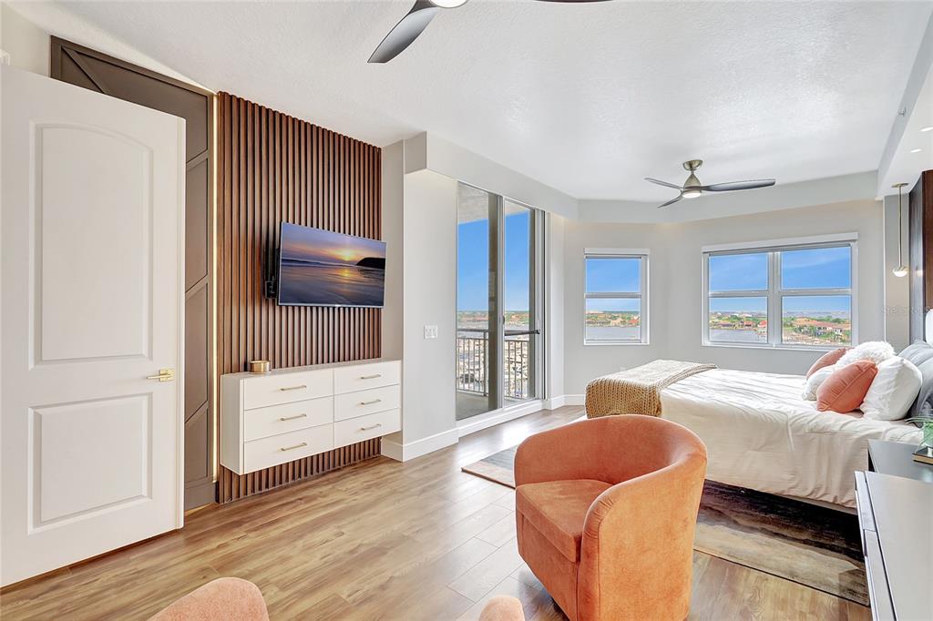 610 Riviera Dunes Way, Unit 602 Palmetto, FL 34221 - Photo 49 of 79 a living room with furniture and a flat screen tv