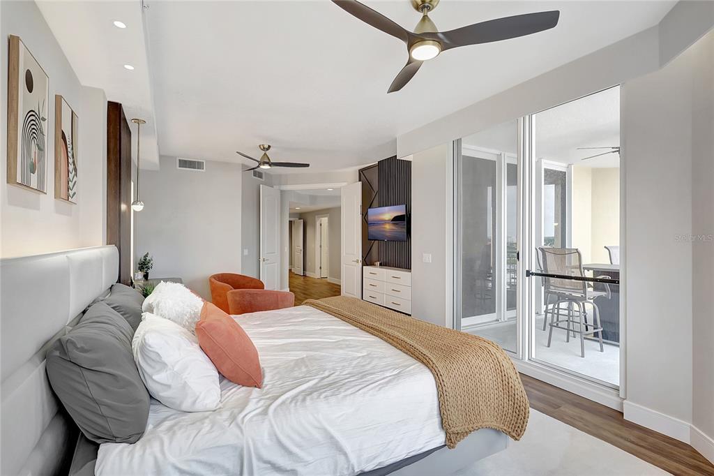 610 Riviera Dunes Way, Unit 602 Palmetto, FL 34221 - Photo 51 of 79 a bedroom with a large bed and a chandelier