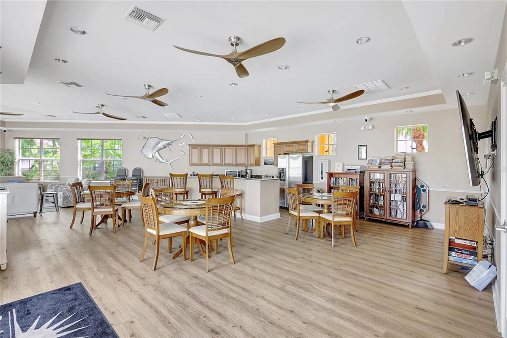 610 Riviera Dunes Way, Unit 602 Palmetto, FL 34221 - Photo 60 of 79 a living room with lots of furniture and wooden floor
