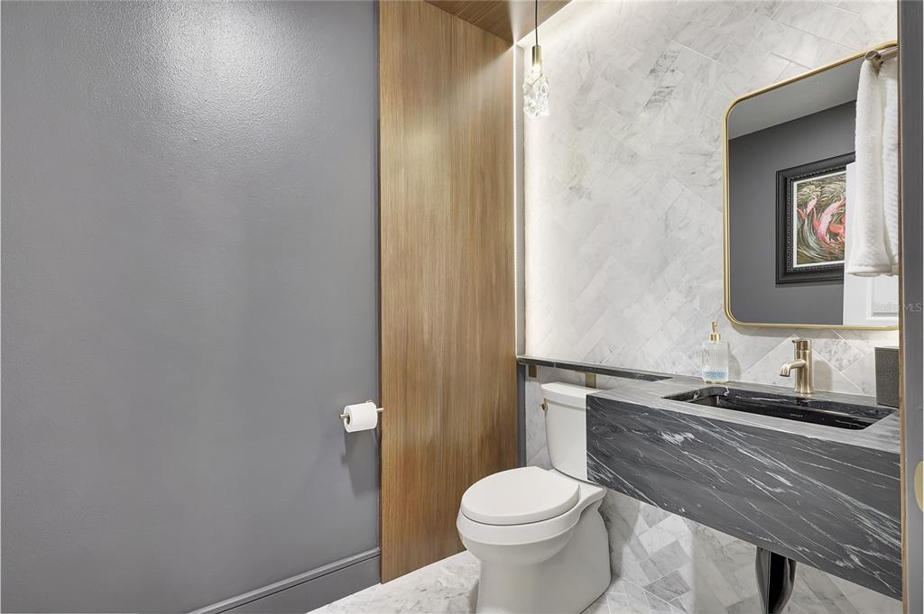 610 Riviera Dunes Way, Unit 602 Palmetto, FL 34221 - Photo 6 of 79 a bathroom with a granite countertop sink toilet and mirror