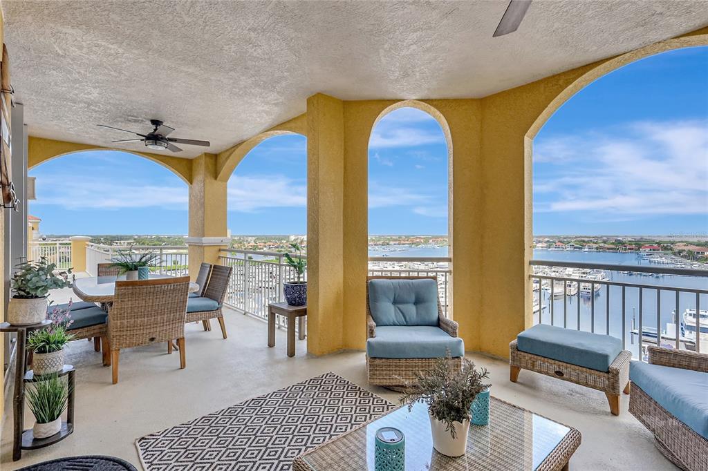 610 Riviera Dunes Way, Unit 602 Palmetto, FL 34221 - Photo 63 of 79 a living room with furniture a rug and a floor to ceiling window