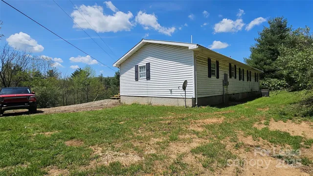 a front view of a house with yard and green space