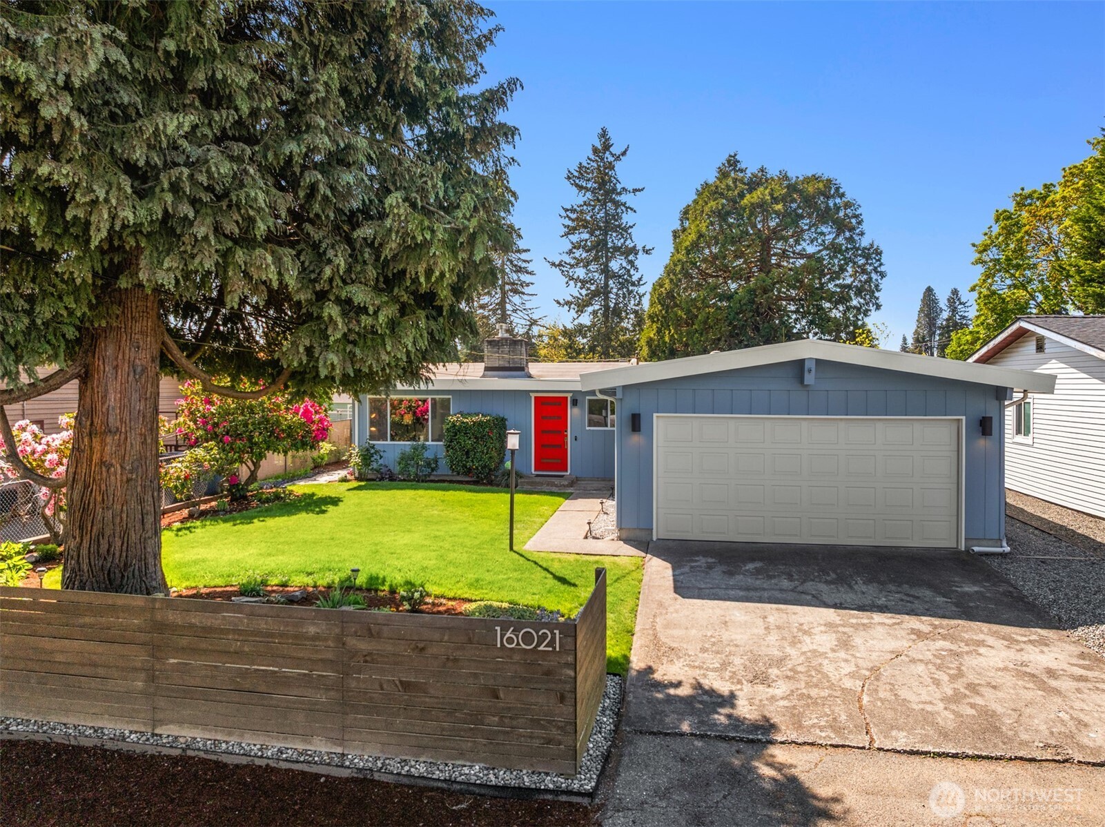 16021 15th Avenue Southwest Burien, WA 98166 - Photo 1 of 36 a front view of a house with a yard and garage