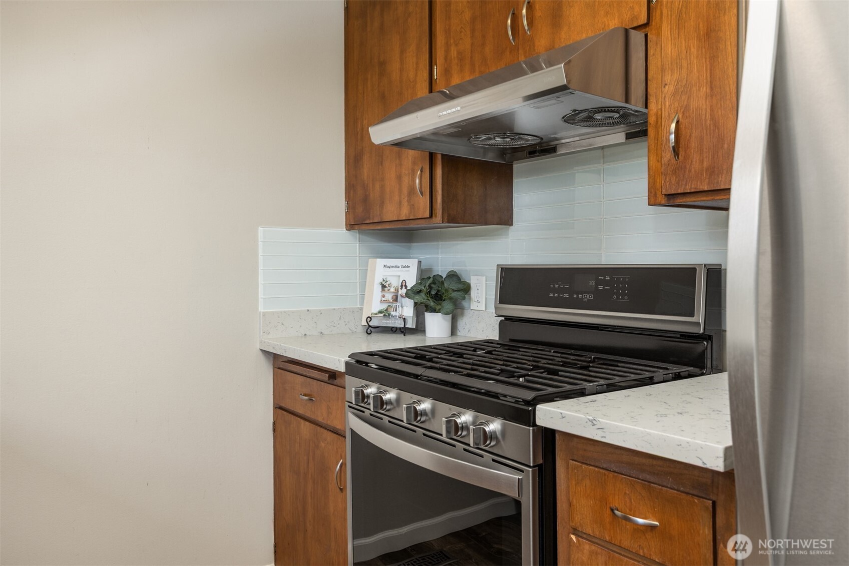 16021 15th Avenue Southwest Burien, WA 98166 - Photo 11 of 36 a kitchen with stainless steel appliances granite countertop a stove and a sink