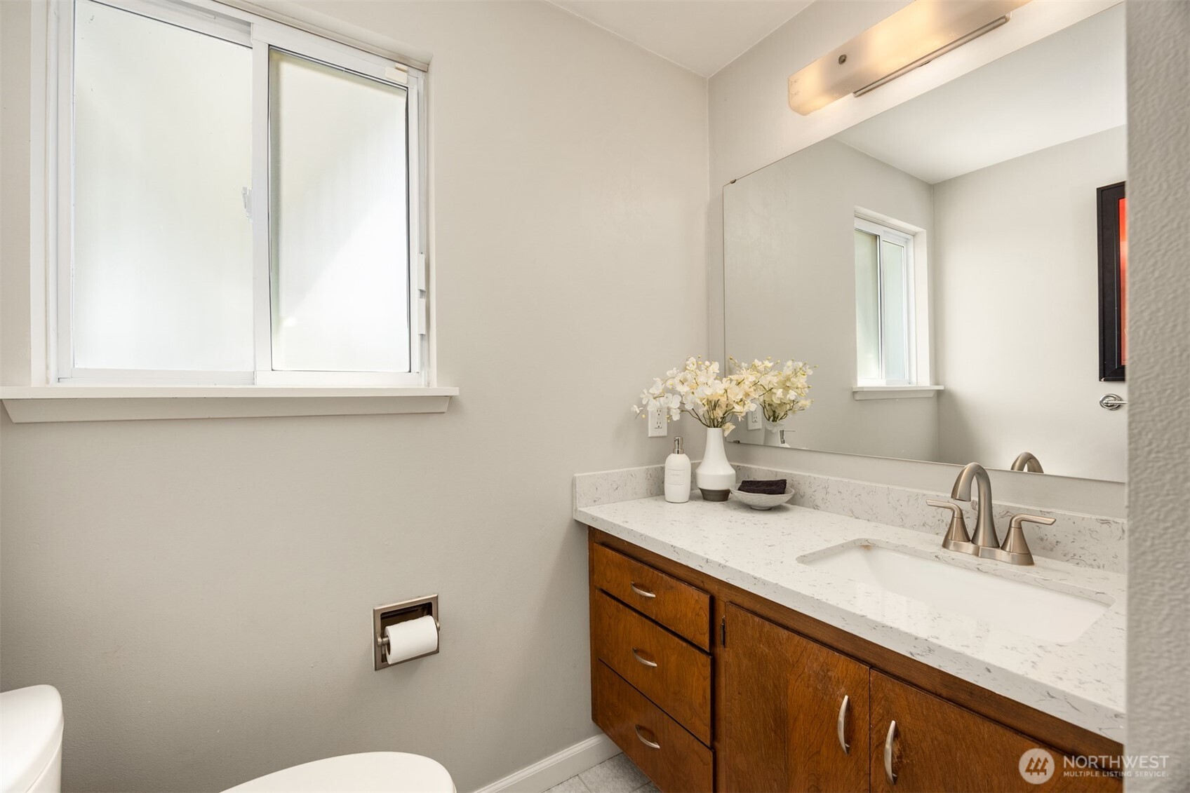 16021 15th Avenue Southwest Burien, WA 98166 - Photo 16 of 36 a bathroom with a granite countertop sink mirror and a toilet