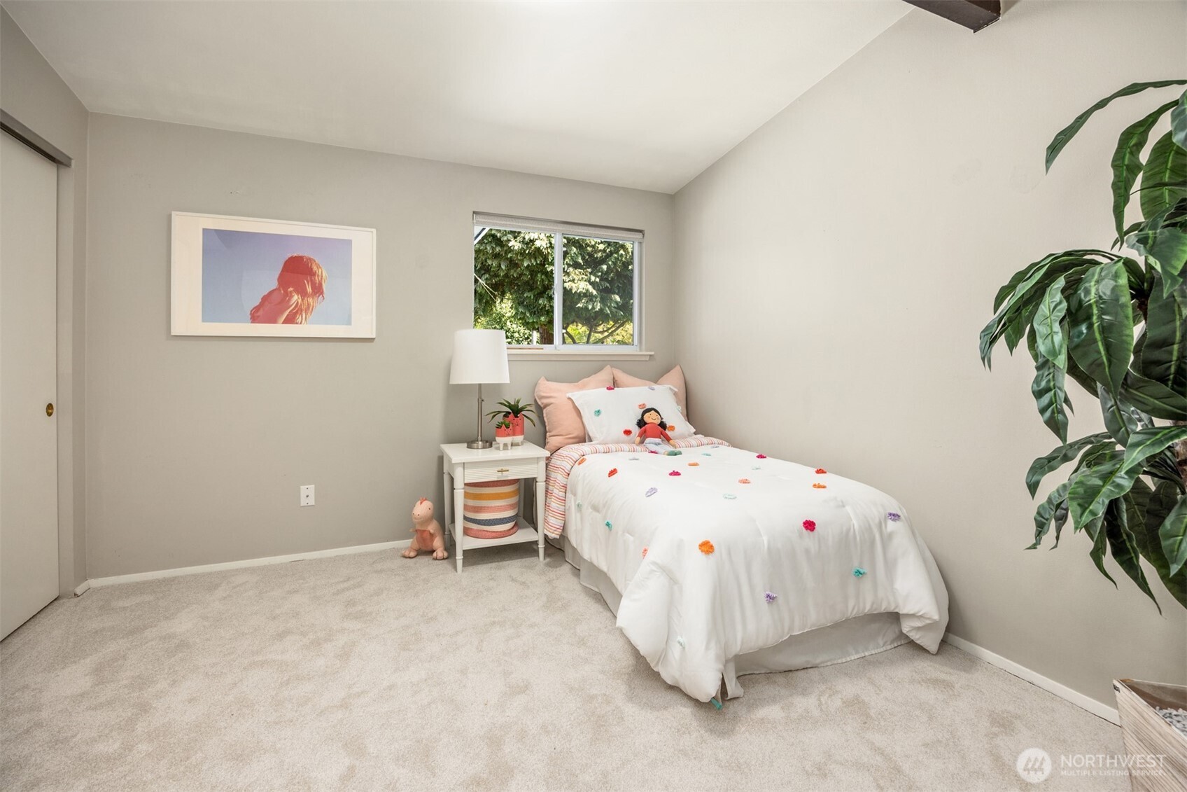 16021 15th Avenue Southwest Burien, WA 98166 - Photo 19 of 36 a bedroom with a bed and a plant