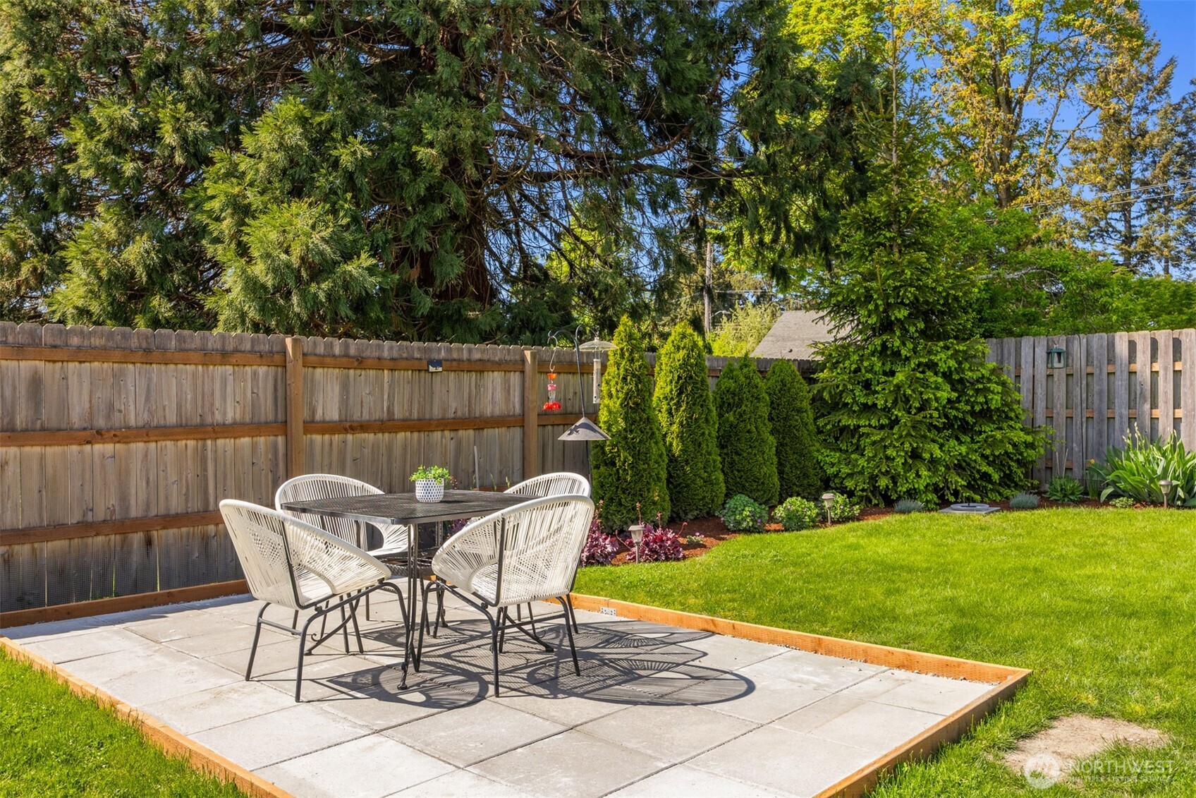 16021 15th Avenue Southwest Burien, WA 98166 - Photo 26 of 36 a patio with table and chairs and potted plants with wooden fence