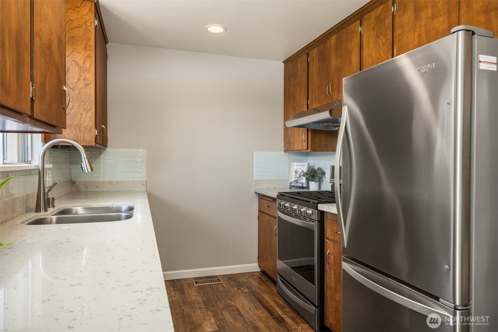 16021 15th Avenue Southwest Burien, WA 98166 - Photo 10 of 36 a kitchen with metallic refrigerator and a sink