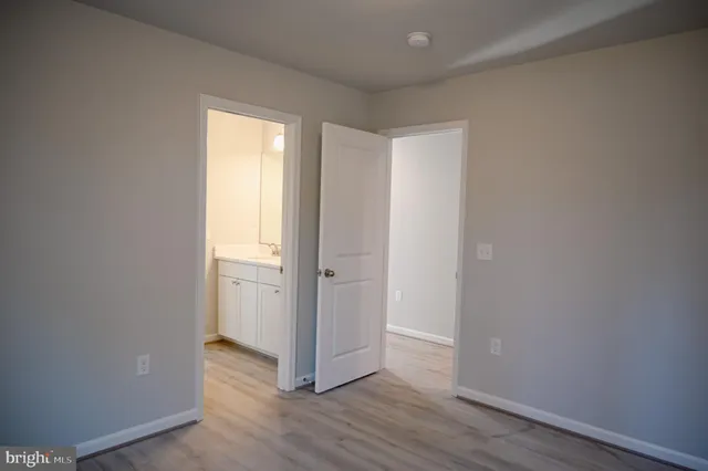 a view of a room with wooden floor