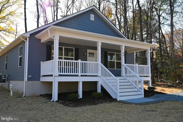 a view of a house with a yard and deck