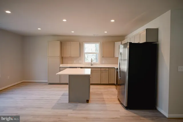 a kitchen with a refrigerator and a sink