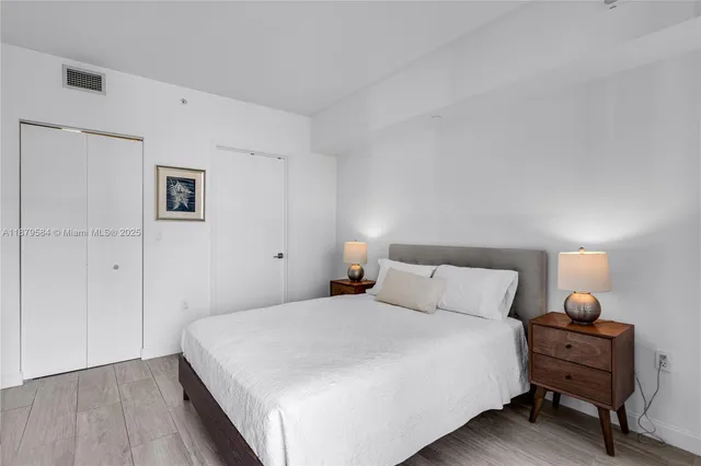 a bedroom with a bed and a lamp on table