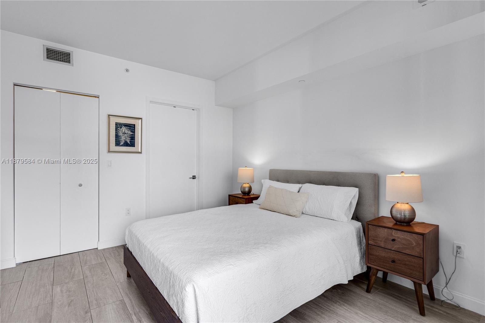 45 Southwest 9th Street, Unit 1001 Miami, FL 33130 - Photo 15 of 40 a bedroom with a bed and a lamp on table