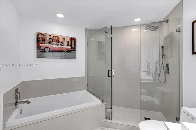 a bathroom with a tub and shower