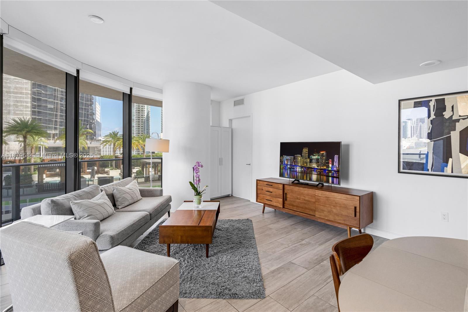 45 Southwest 9th Street, Unit 1001 Miami, FL 33130 - Photo 8 of 40 a living room with furniture and a flat screen tv