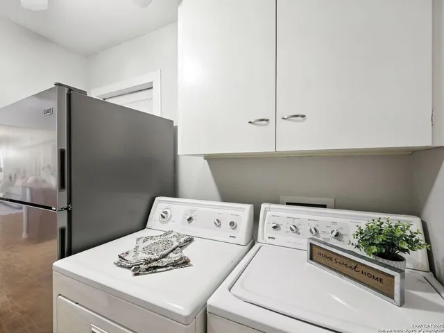 a kitchen with a white stove top oven and refrigerator