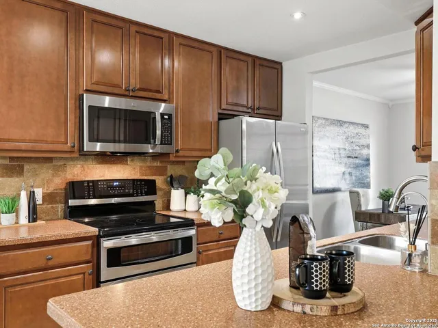 a living room with furniture a fireplace and a potted plant