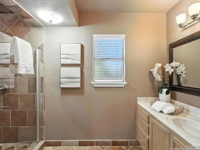 a bathroom with a granite countertop sink a toilet and a mirror