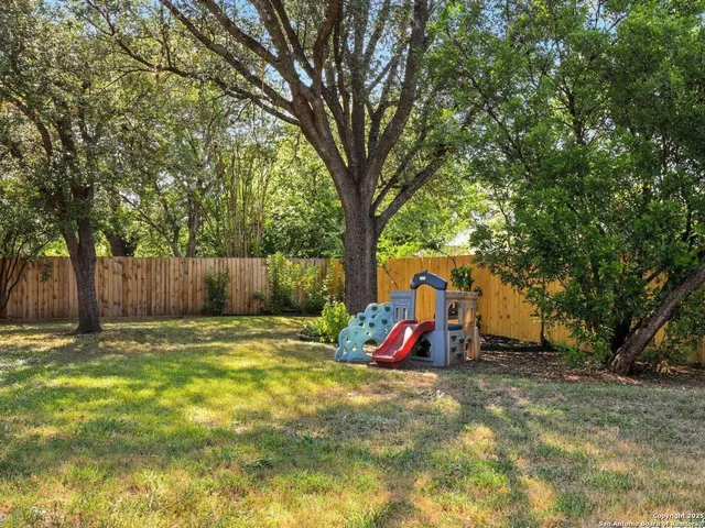 a view of outdoor space with garden and trees