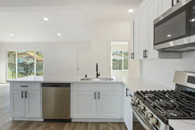a kitchen that has a sink and a stove