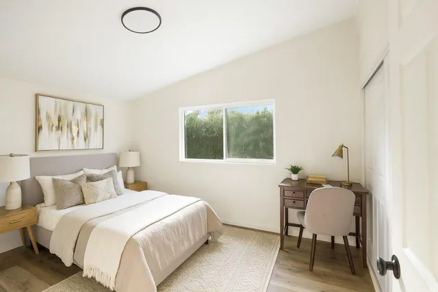 a bedroom with a bed and a window