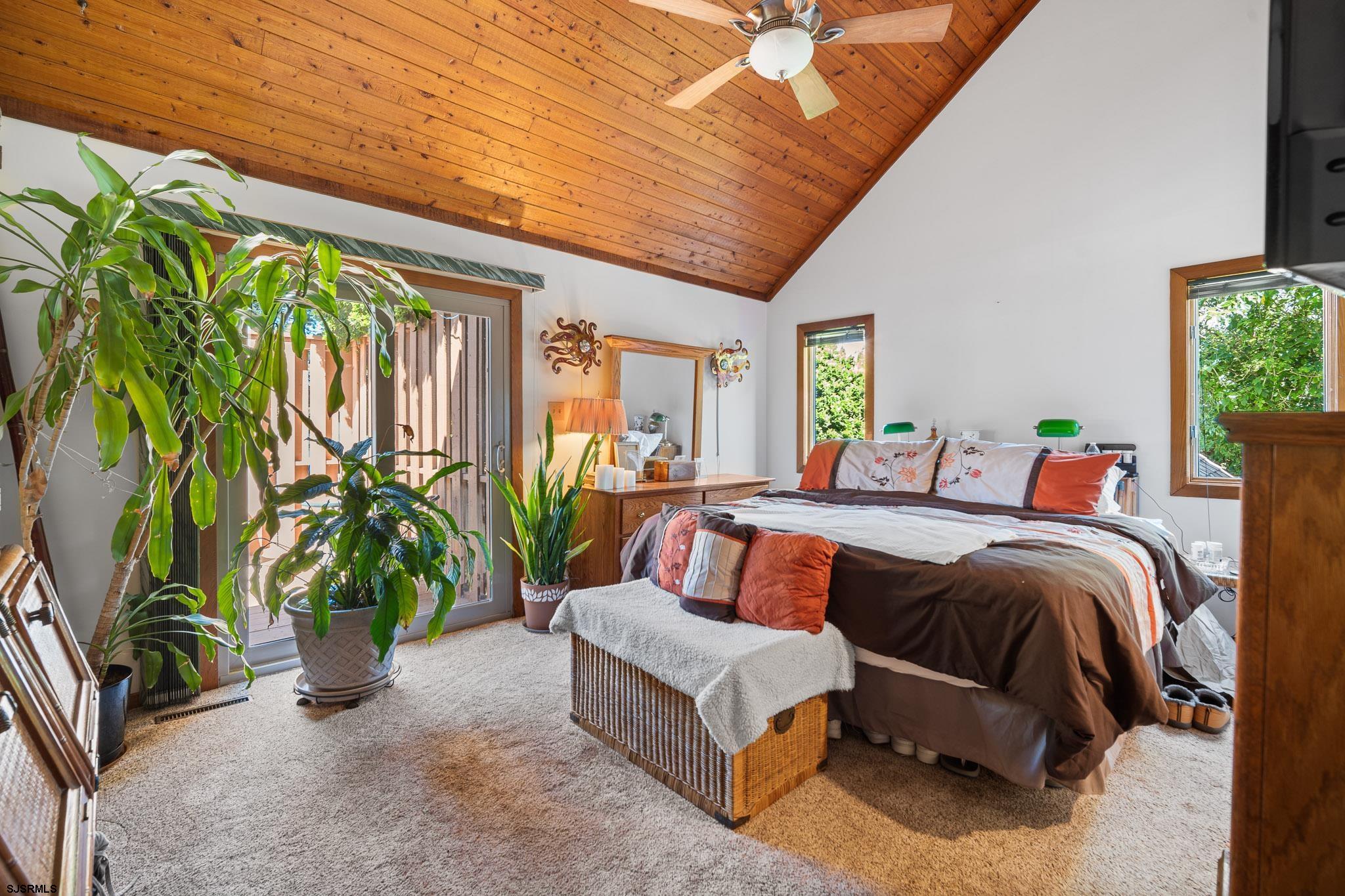 202 North Shore Road Marmora, NJ 08223 - Photo 20 of 31 a spacious bedroom with a large bed and a potted plant