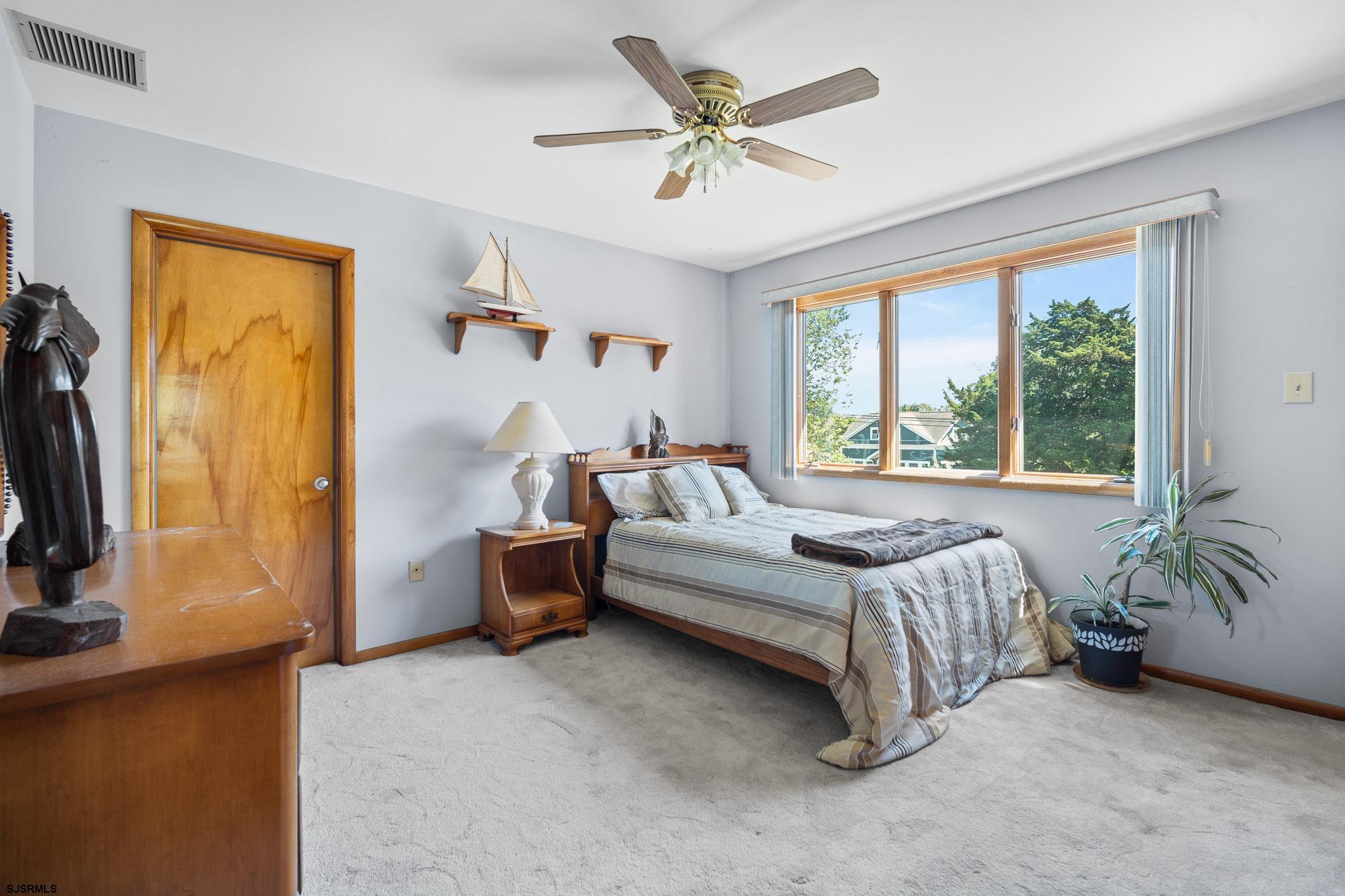 202 North Shore Road Marmora, NJ 08223 - Photo 27 of 31 a bedroom with a bed and a flat tv screen