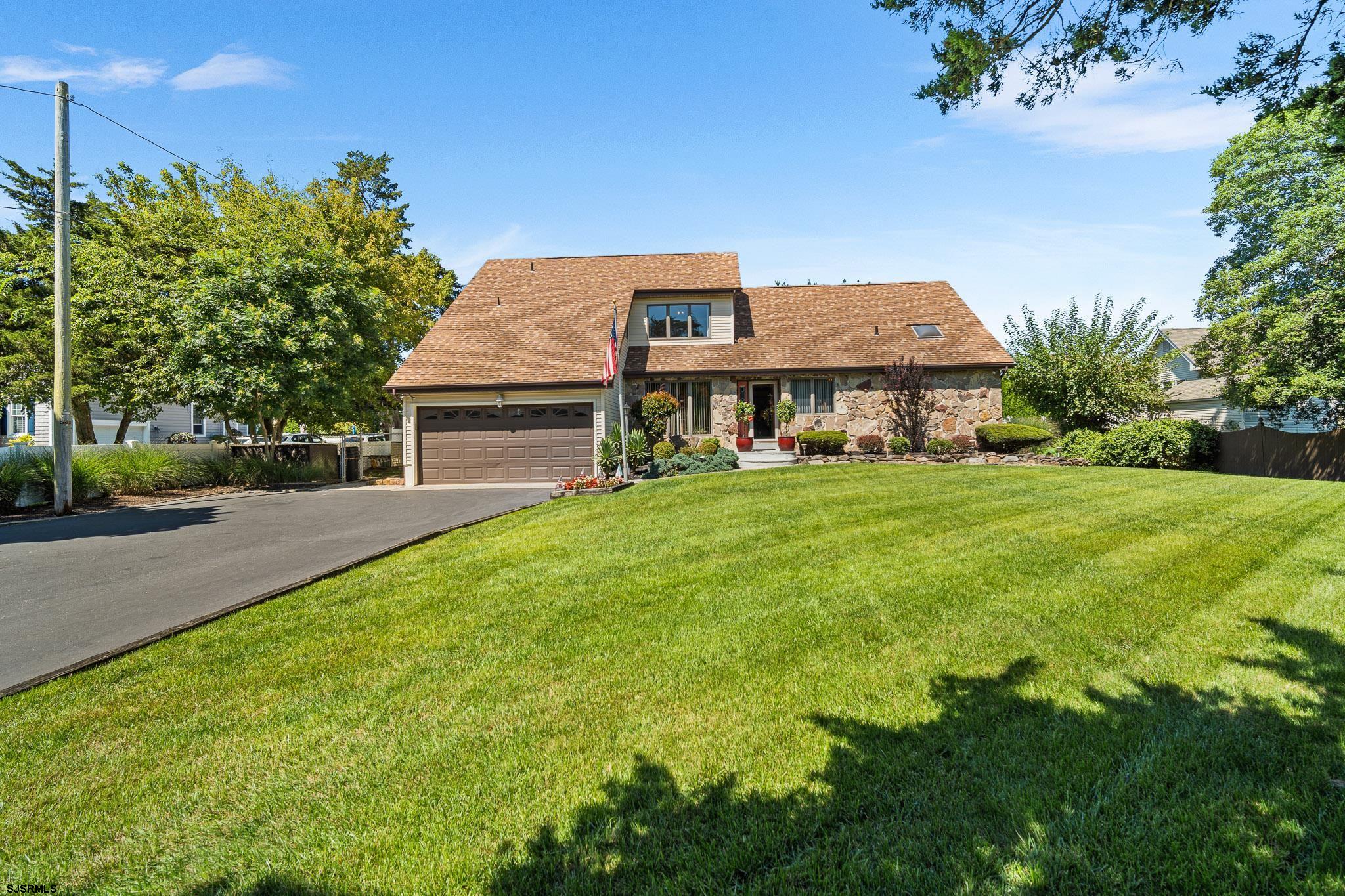 202 North Shore Road Marmora, NJ 08223 - Photo 4 of 31 a front view of a house with garden