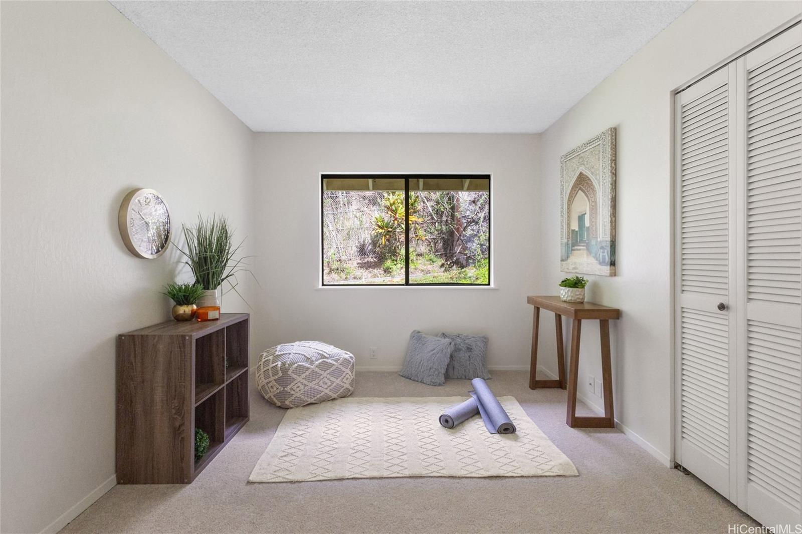 1630 Kalaniiki Street, Unit 31 Honolulu, HI 96821 - Photo 12 of 25 a bedroom with a large bed and a chandelier