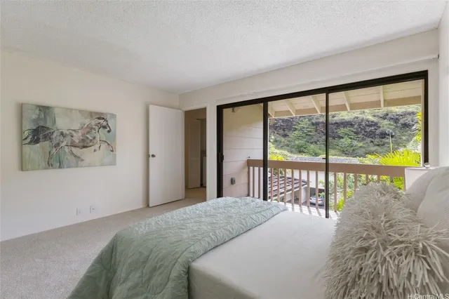 a bedroom with a large bed and a large window