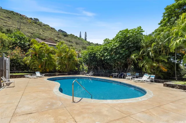 a view of a swimming pool and lounge chairs