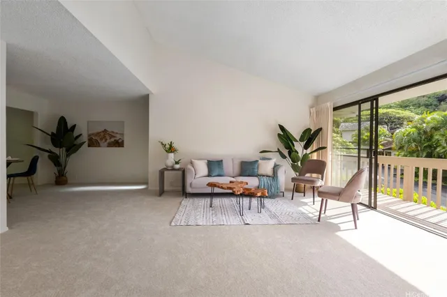 a living room with furniture large window and potted plants