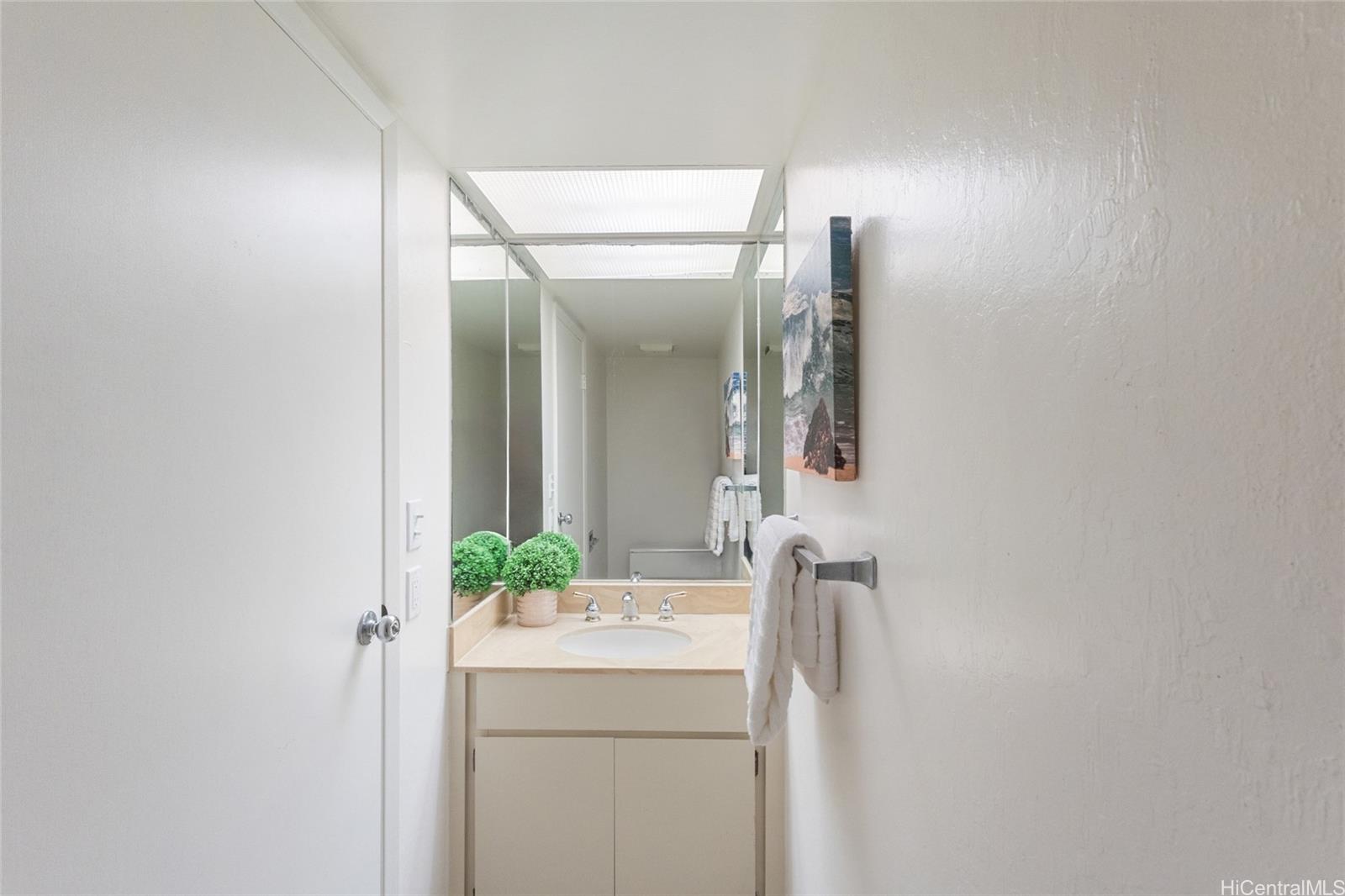1630 Kalaniiki Street, Unit 31 Honolulu, HI 96821 - Photo 8 of 25 a bathroom with a granite countertop sink and a mirror