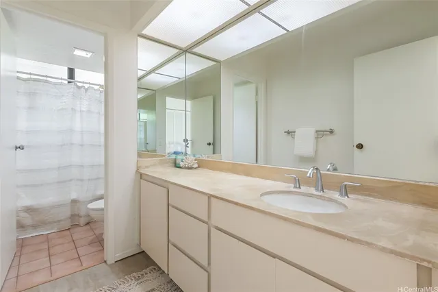a bathroom with a granite countertop sink and a mirror