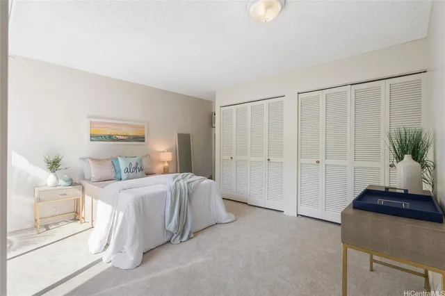 a bedroom with a bed and a potted plant