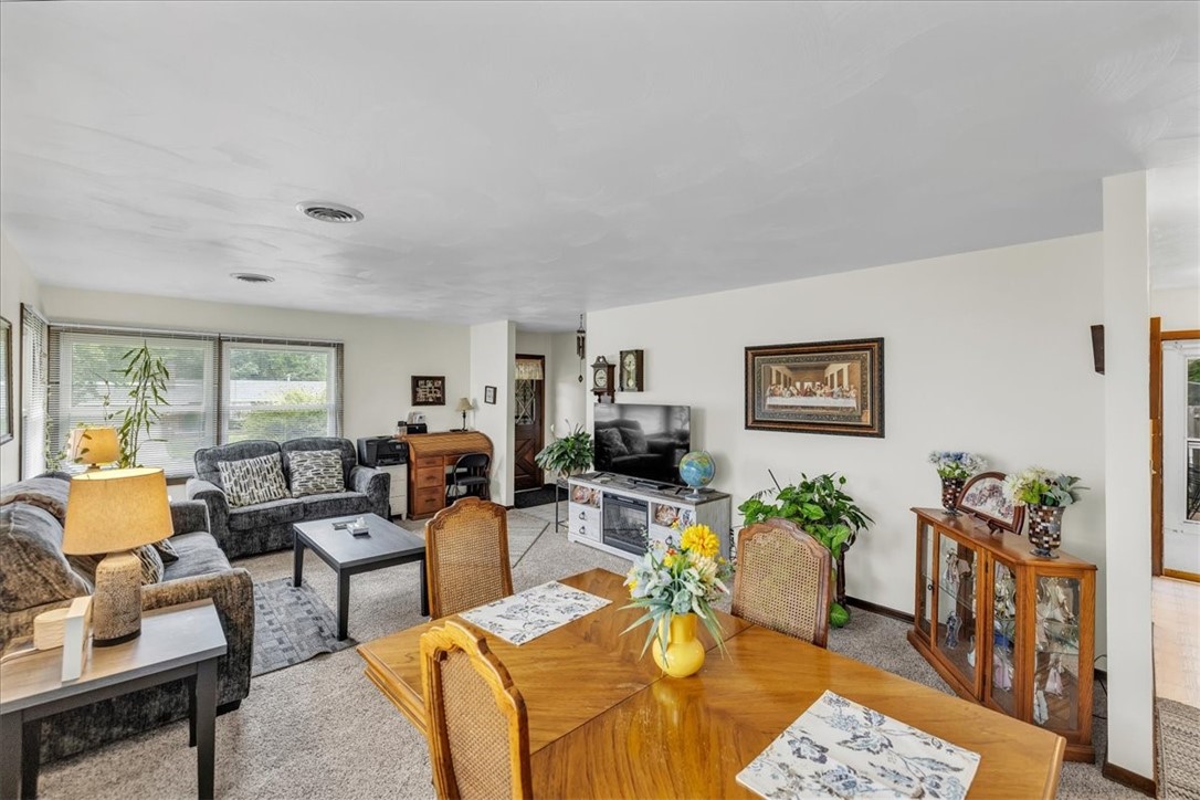 2220 West Ravina Park Road Decatur, IL 62526 - Photo 5 of 36 a living room with furniture floor to ceiling window and a flat screen tv