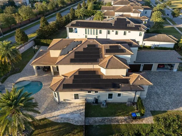 an aerial view of a residential houses with outdoor space