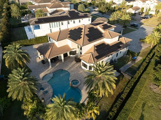 an aerial view of a house with garden space and outdoor seating