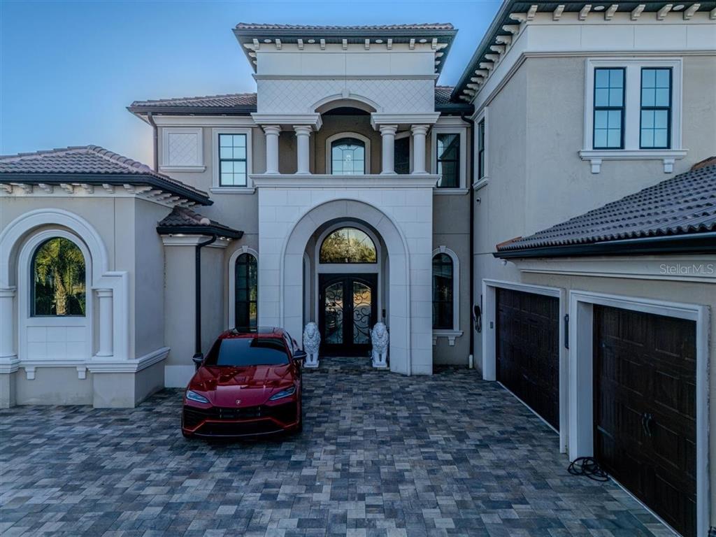4303 Isabella Circle Windermere, FL 34786 - Photo 2 of 77 a front view of a house with garden