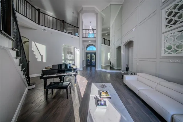 a large kitchen with a large counter top a sink stainless steel appliances and cabinets