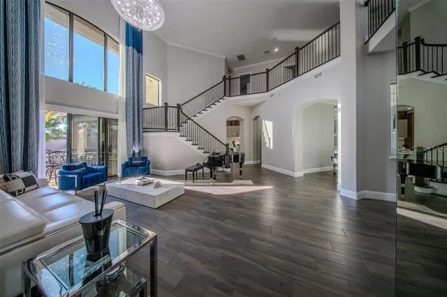 a dining room with furniture and a floor to ceiling window