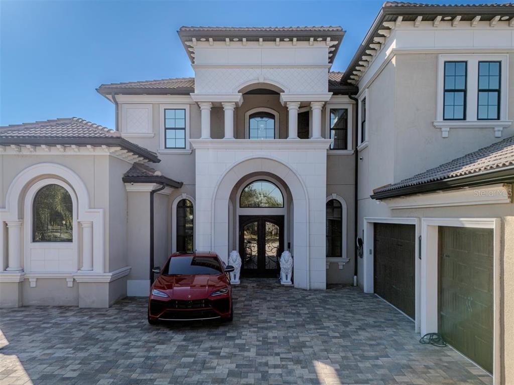 4303 Isabella Circle Windermere, FL 34786 - Photo 3 of 77 a front view of a house with a garden