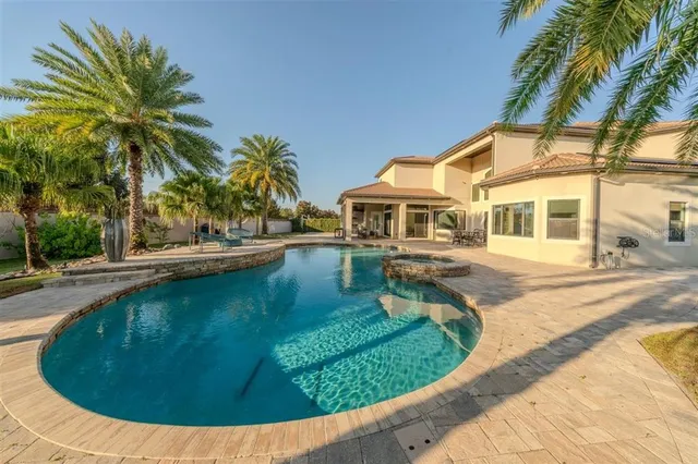 a bedroom with bed and a chandelier