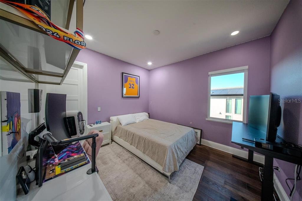 4303 Isabella Circle Windermere, FL 34786 - Photo 58 of 77 a bedroom with a bed and a flat screen tv