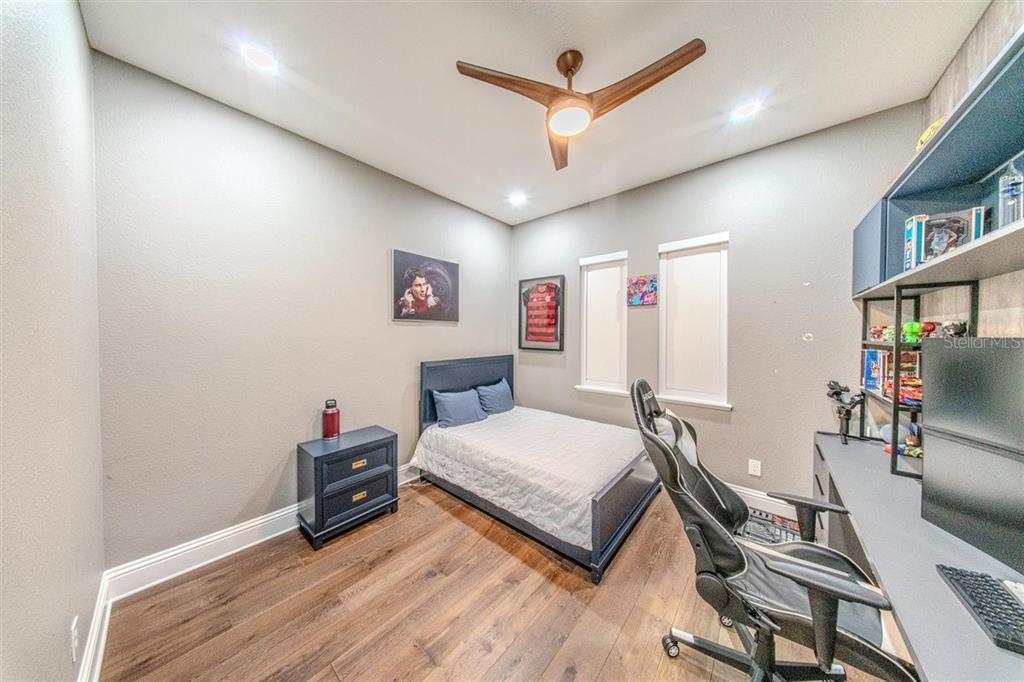 4303 Isabella Circle Windermere, FL 34786 - Photo 59 of 77 a bedroom with a bed a desk and chair