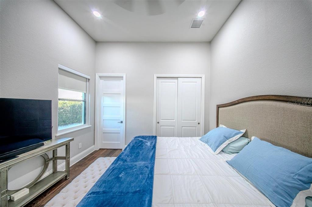 4303 Isabella Circle Windermere, FL 34786 - Photo 71 of 77 a bedroom with a bed and a flat screen tv